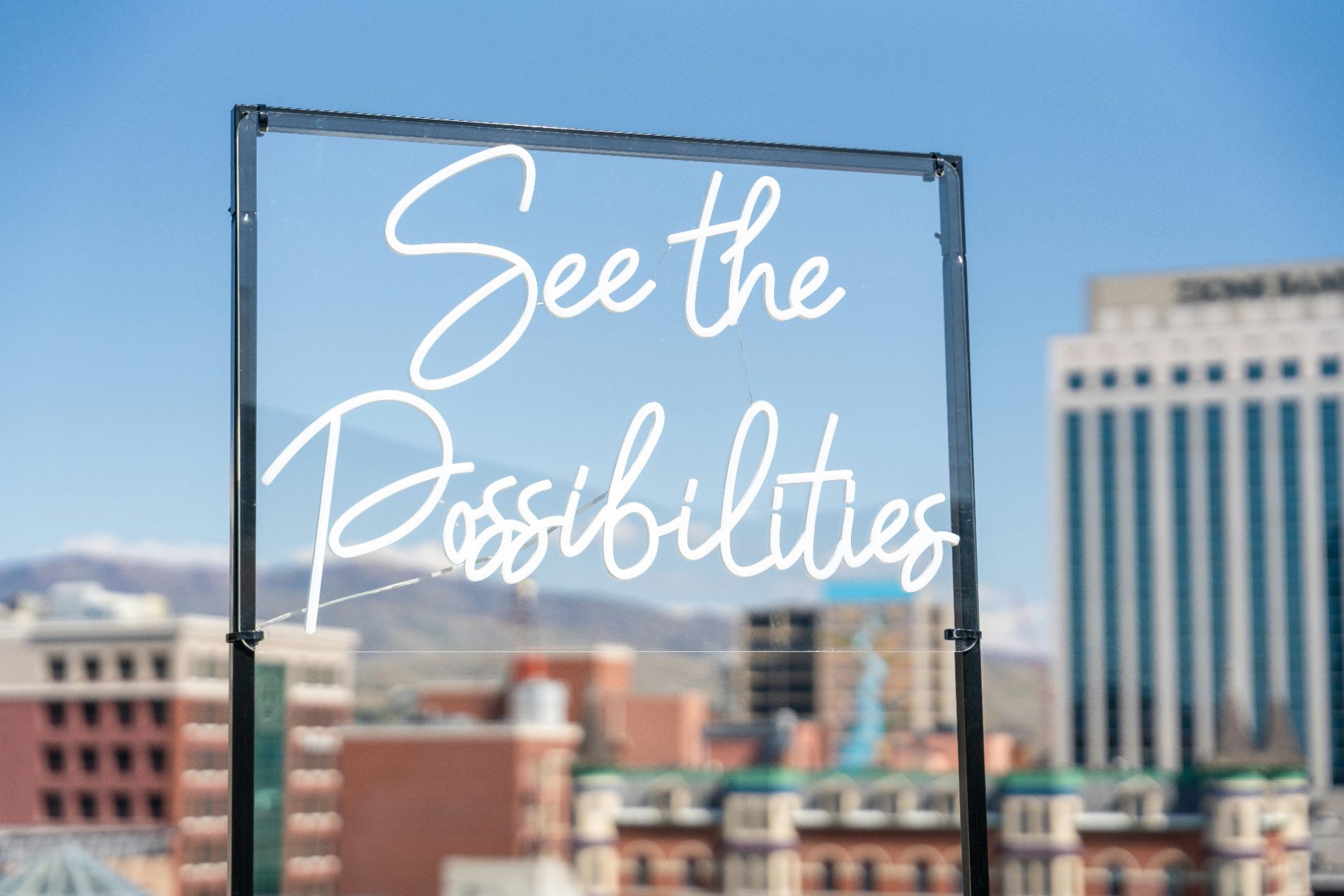 A 'See the Possibilities' sign overlooking a city skyline