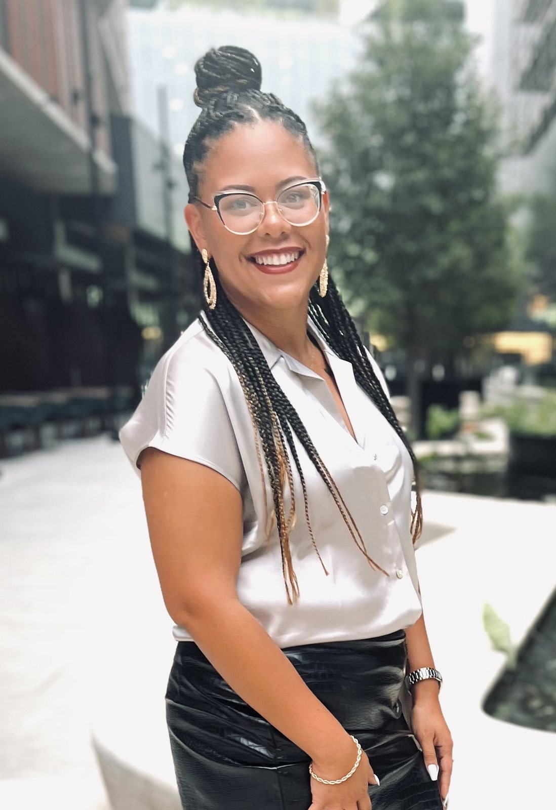 Kassandra Ayala smiling outdoors in a city courtyard