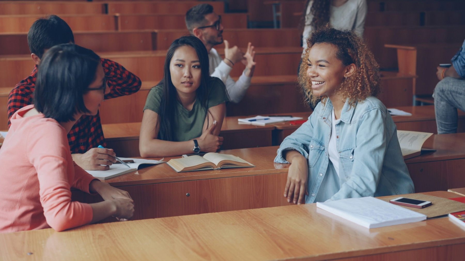 Teenagers talking and working together in a classroom workshop
